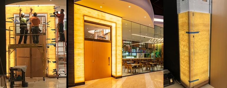 Backlit honey onyx feature wall with LED illumination in a casino interior